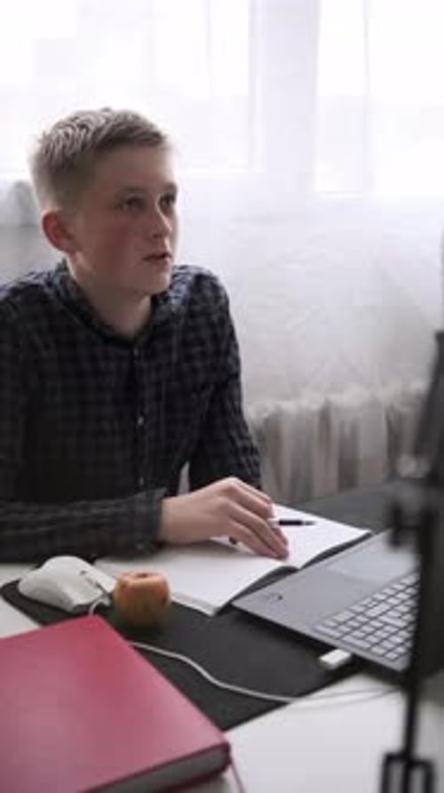 Boy Studies with Laptop at Home Desk