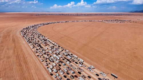 Huge quantity of cars standing in line in the desert.