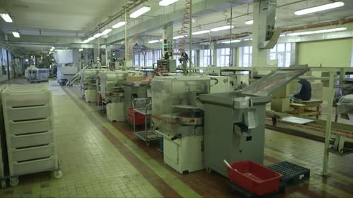 several lollipop packaging machines in a candy factory