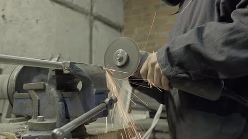 Man Use Electric Circular Saw Industrial Machine Sparks Fly Circular Saw Spinning on Metal Parts
