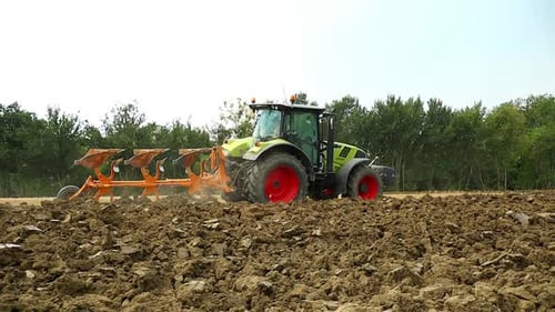 Tractor Plowing Field on a Sunny Day