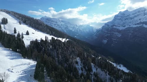 Drone shot of Fronalpstock mountains with beautiful skyscape at background in Glarus, Switzerland. A