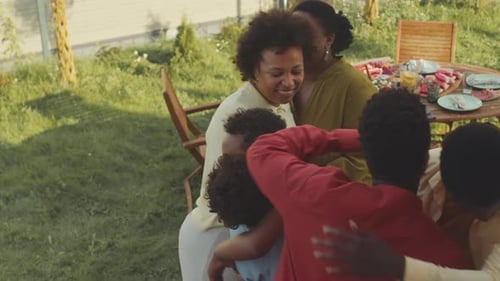 Happy Family Embraces at Outdoor Gathering