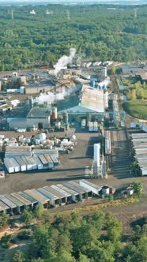 Industrial Facility with Large Storage Areas and Processing Equipment Set in a Natural Landscape