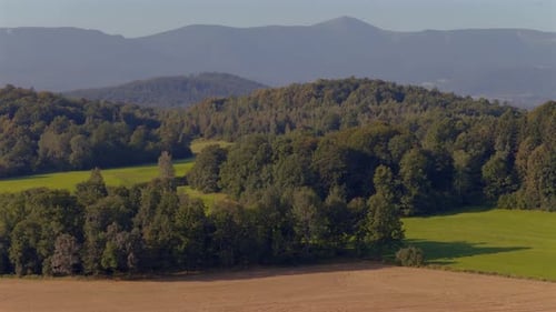 Scenic Drone View of Rolling Hills and Forest