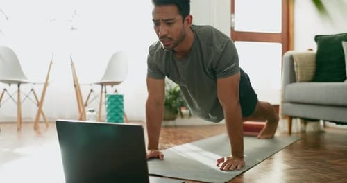 Man Exercising with Laptop at Home