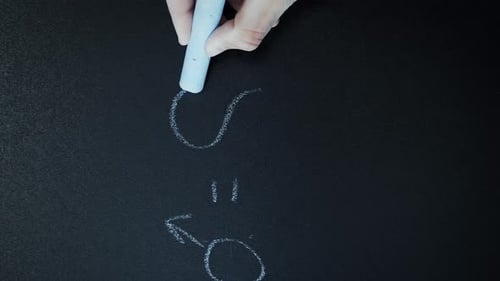 Hand Draws Male and Female Symbols with Chalk