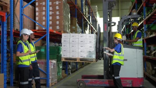 Warehouse worker controlling boxes in warehouse, Professional male warehouse worker moving cardboard