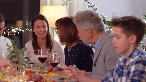 Family Celebrates Together at Dinner Table in Home