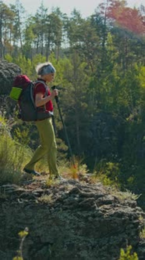 Senior Woman Hiking with Backpack in the Forest