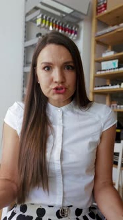 Woman Talking To Camera in Office Setting