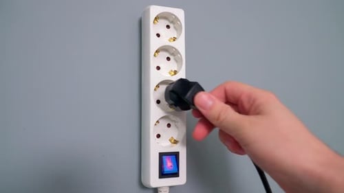 Plugging Power Cord Into Outlet Strip