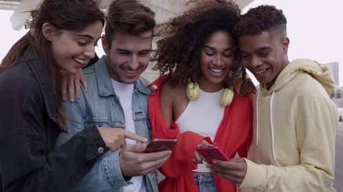 Group of Friends Sharing Phone Smiling and Laughing