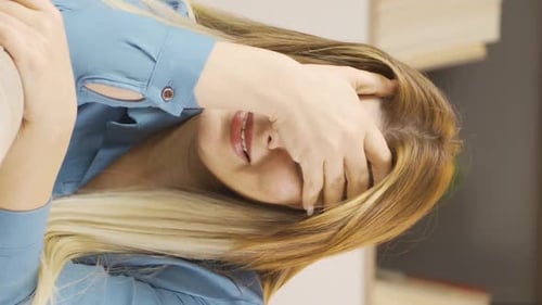 Blonde Woman on Couch Covering Face