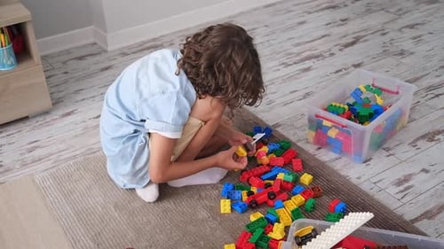 Little Toddler Boy Playing with Colorful Plastic Blocks at Home Building Creative Game Imagination