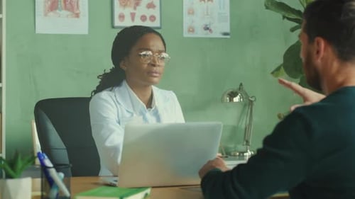 Doctor consulting with a male patient in office