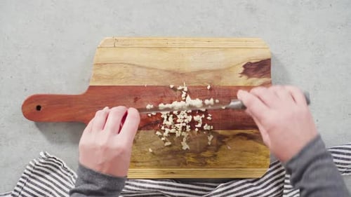 Cutting Organic Garlic on a Wood Cutting Board