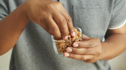 Close Up of Almond Nuts on Man's Hand