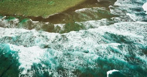 waves reach the deserted sandy beach