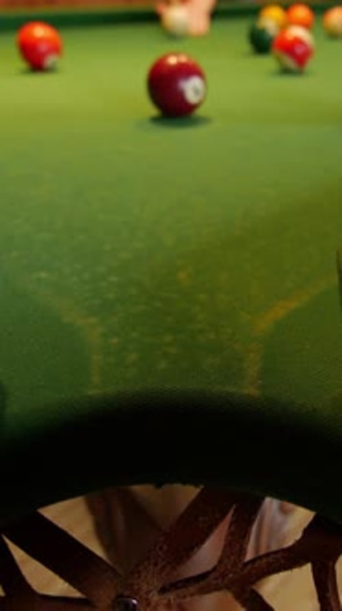 Closeup of a Billiard Table with Balls in Play Focusing on the Green Felt Surface Vertical Video