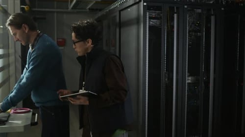 Network Engineers Entering Server Rack in Data Center