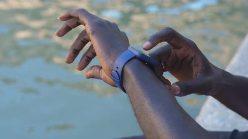 Adult Using Blue Smartwatch Outdoors Close Up