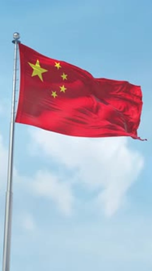 Chinese Flag Waving Against Clear Blue Sky