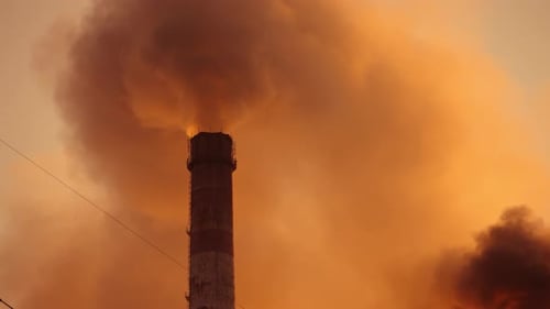 Thick fumes from industrial chimneys smoking. Clouds of dirty emissions pollute the atmosphere.