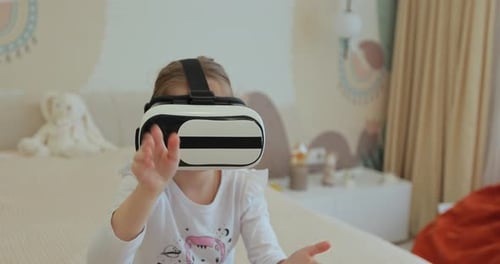 Girl Wearing VR Headset Playing Game on Bed