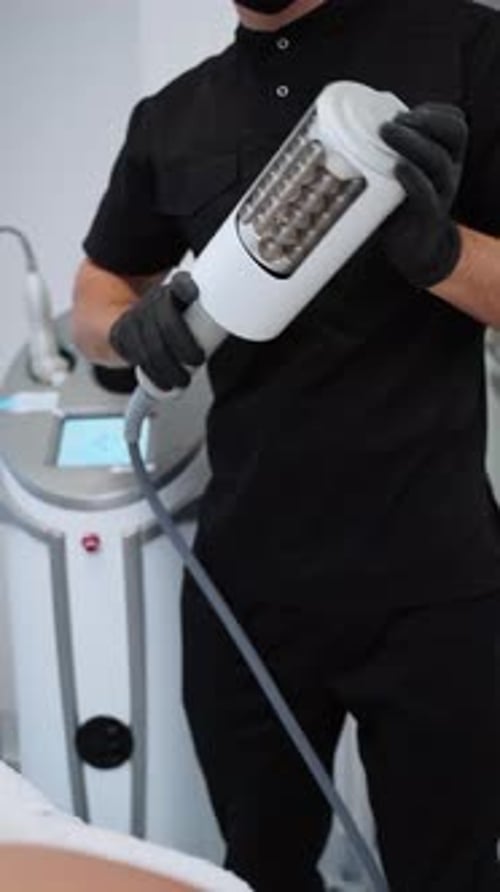 Professional Aesthetician Performs Endospheres Therapy for Cellulite Reduction in Modern Clinic with