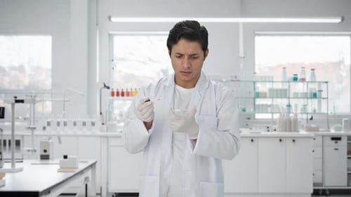 Scientist Mixing Liquid With Pipette in Bright Lab