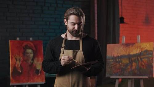 Painter Blending Various Colors on Art Palette with Brush