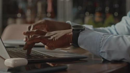 Close Up Of Hands Typing On A Laptop