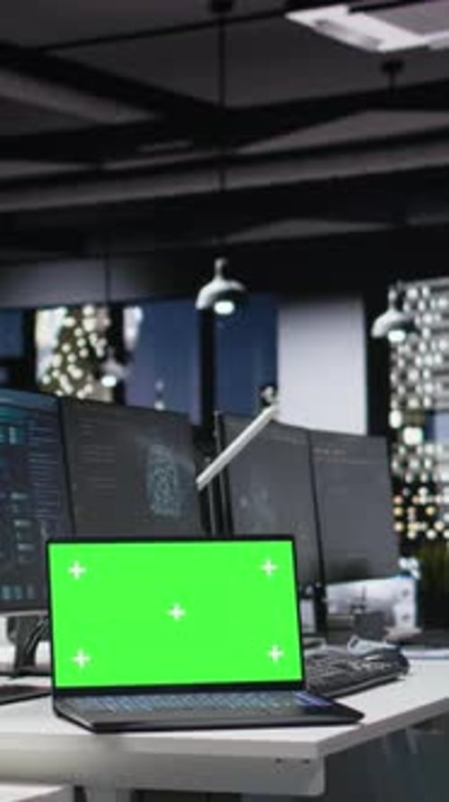 Laptop with Green Screen in Modern Office