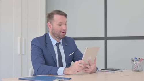Adult Having Tablet Video Call in Modern Office