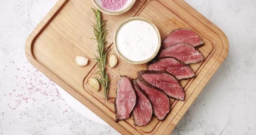 Overhead View of Sliced Meat on Cutting Board