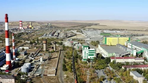 An Aerial Perspective of an Industrial Complex Featuring Smoke Stacks and Various Facilities Stock