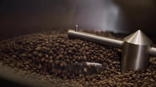 Coffee beans are being mixed in a large machine