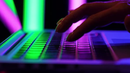 Close Up of Fingers Typing on a Colorful Laptop Keyboard