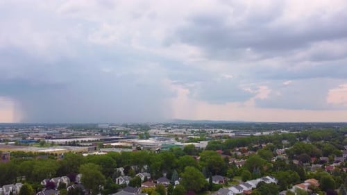 Aerial Drone Pans Over a Rainstorm on the Horizon in Sainte-Catherine, Canada.