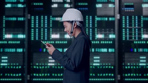 Asian Businesswoman Use Tablet While Walking and Looking Around in Data Center