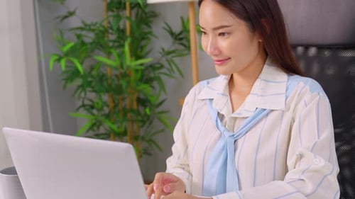 Asian beautiful businesswoman using laptop computer working in office.