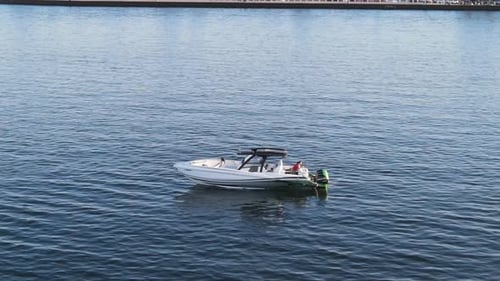 Person Enjoying Susnet View From A Boat Floating In The Lake Pontchartrain In New Orleans, Louisiana