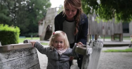 Mother and daughter in playground playing