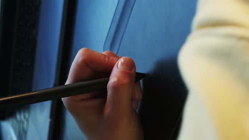 Female hand drawing with stylus on pen tablet