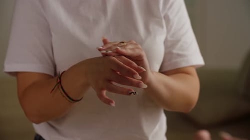 Woman Applies Moisturizer To Her Hands