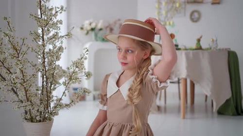 Charming Girl in Vintage Dress and Straw Hat Spring Decor with Blooming Branches Indoors Child
