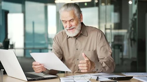 Man at Desk Celebrates Good News