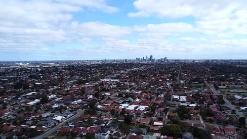 Aerial view - Perth suburban real estate housing to CBD on horizon