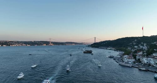Istanbul Bosphorus Bridge and City Skyline in Background with Turkish Flag at Beautiful Sunset